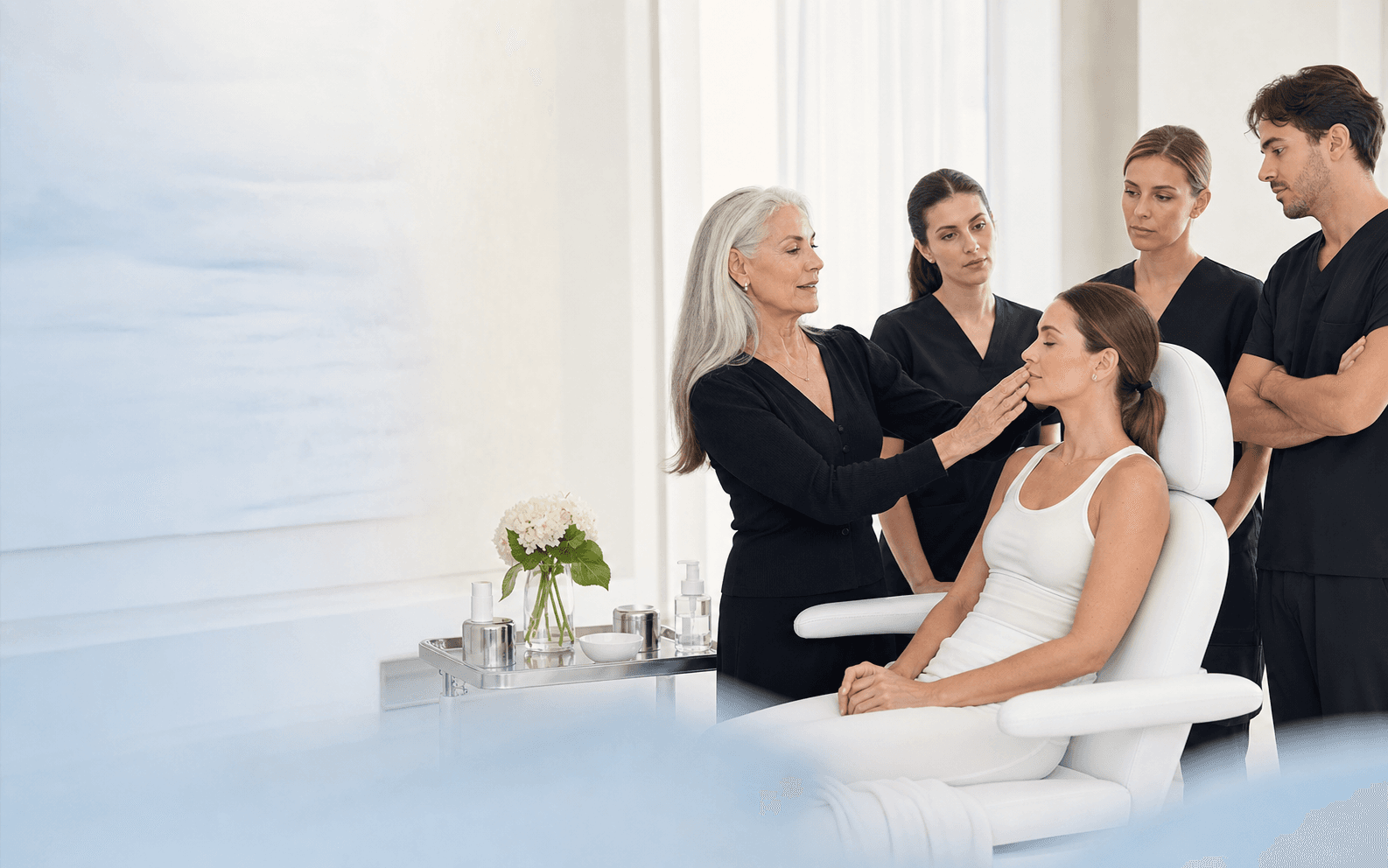 Aesthetic medicine educator guiding practitioners around a model patient